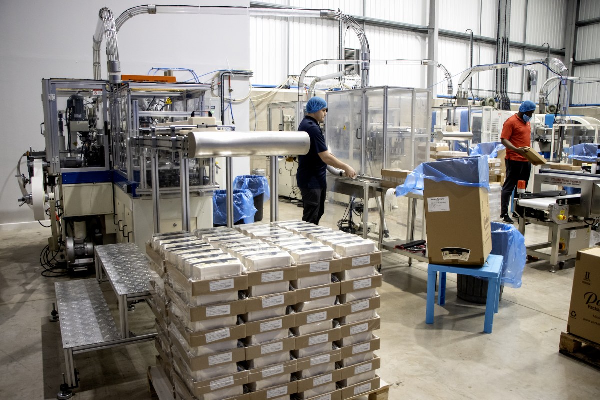 Wholesale food packaging containers stacked in a UK factory ready for bulk delivery and distribution